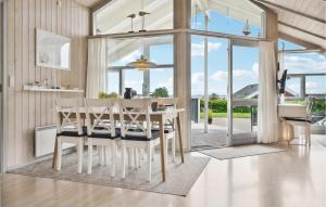 a dining room with a white table and chairs at Cassiopeia in Sjølund