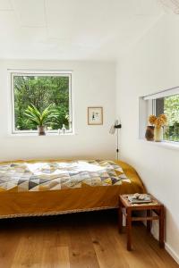 a bedroom with a bed and a window at Personally Furnished Holiday Home Near The Beach in Vejby