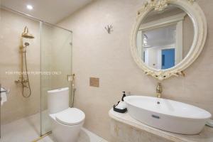 a bathroom with a toilet and a sink and a mirror at SILK CLASSIC HOTEL & TRAVEl in Hanoi