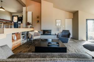 a living room with a couch and a table at Hilltop Sheepfold In Castelnou in Cazilhac