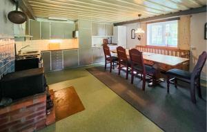 a kitchen and dining room with a table and chairs at 2 Bedroom Awesome Home In Östmark in Östmark