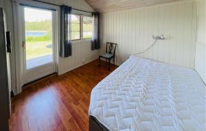 a bedroom with a bed and a large window at 2 Bedroom Awesome Home In Östmark in Östmark