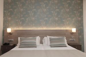 a bedroom with a large bed with two pillows at Hotel Puerto Palace in Puerto de la Cruz