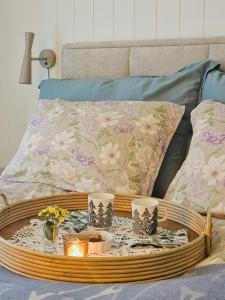 a wooden tray with candles and flowers on a bed at Cabin By Langfjorden With Sauna And Midnight Sun in Svanvik