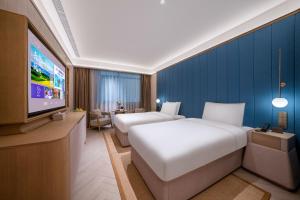 Jingdong Headquarters Crystal Orange Hotel, Yizhuang, Beijing房間的床 +37 張相片