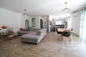 a living room with a couch and a table at A pretty family house located in a tranquil area with a pretty view of the Luberon range. in Les Taillades