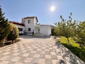 a large white house with a stone driveway at 4 bed room Villa Alsancak Girne in Lageia