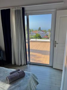 a bedroom with a large sliding glass door to a balcony at 4 bed room Villa Alsancak Girne in Lageia