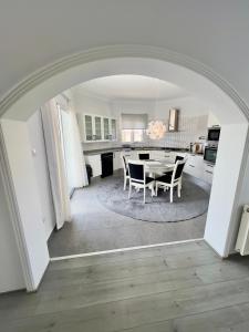an archway in a kitchen with a table and chairs at 4 bed room Villa Alsancak Girne in Lageia +8 photos