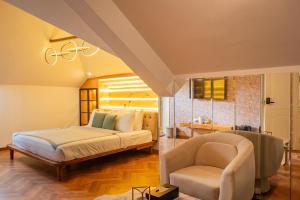a bedroom with a bed and a chair at ELIVAAS Signature Casa Ritzy Mediterranean 5 BHK Hideaway with Pool near Popular Beaches in Calangute