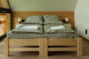 a bedroom with a bed with two towels on it at Chata u Przewodnika in Ostrowsko