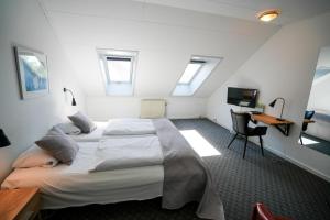 Postel nebo postele na pokoji v ubytování Hotel Søparken