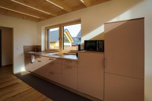 a kitchen with a refrigerator and a microwave at Chalet Auszeit im Schönseer Land in Schönsee