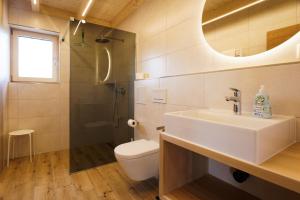 a bathroom with a sink and a toilet and a shower at Chalet Auszeit im Schönseer Land in Schönsee +27 photos