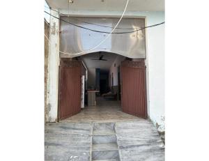 an empty hallway in an old building with awning at SLH guest house in Faizābād