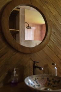 a bathroom with a sink and a mirror at Natural, warm, tropical villa in Tanah Lot