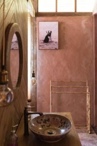 a bathroom with a sink and a mirror at Natural, warm, tropical villa in Tanah Lot