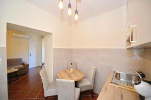 a kitchen with a wooden table in a room at Kuzman Apartments in Kotor +49 photos