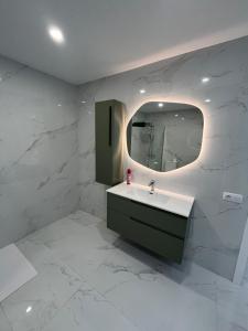a bathroom with a sink and a mirror at Luxury Penthouse BBQ Chill out terrace in Los Realejos