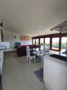 a kitchen and living room with a table and chairs at La Buena Vida, el Palmar in El Palmar