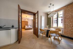 a kitchen and dining room with a table and chairs at Hans Benkner Aparthotel - Premium Apartments in Old Town in Braşov