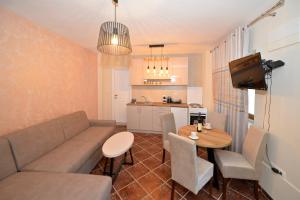 a living room with a couch and a table at Kuzman Apartments in Kotor