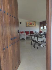 a door to a room with a table and chairs at La Buena Vida, el Palmar in El Palmar