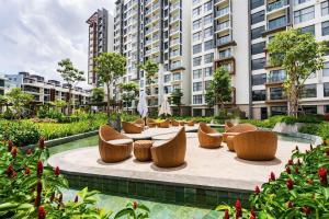 a patio with chairs and a table and buildings at Nhà của Hải - Apartment Luxury Diamond Brilliant in Ho Chi Minh City