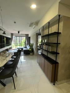 a living room with chairs and a book shelf at Nhà của Hải - Apartment Luxury Diamond Brilliant in Ho Chi Minh City