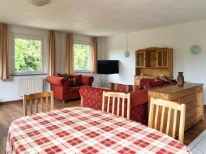 a living room with a bed and a couch at Große Ferienwohnung mit Weitblick in Wesenberg