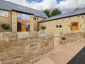 a stone retaining wall in front of a house at Heron View in Preston