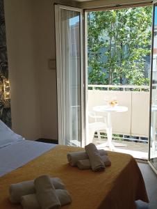 a bedroom with a bed with two towels on it at Hotel CARLO in Riccione