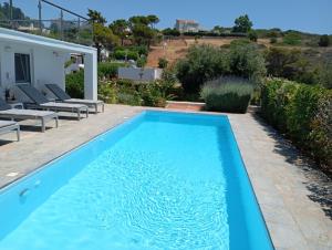 a swimming pool in the backyard of a house at Anemelia & Helios Studio in Anavyssos