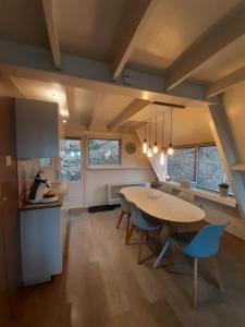 a kitchen and dining room with a table and chairs at bungalow 199 durbuy in Durbuy +25 photos