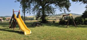 a playground with a slide and a picnic table at La Casa di Edo 