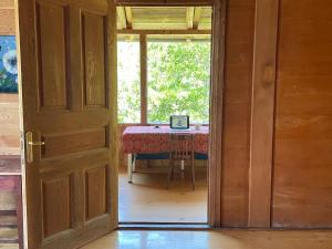 an open door leading to a table with a laptop on it at Milky Way Guest House in Znakva