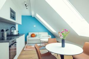 a living room with a table and a couch at LeonArt Living 61 in Graz