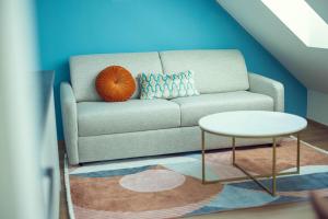 a living room with a couch and a table at LeonArt Living 61 in Graz