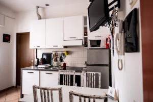 a kitchen with white cabinets and a refrigerator at Comodità a due passi dal centro di Verbania in Verbania