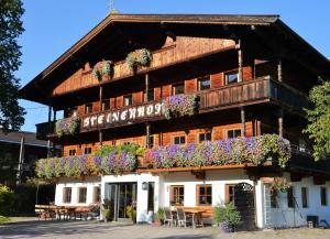 a building with flowers on the front of it at Pension Steinerhof in Oberau
