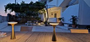 two gold stools sitting on a table in a patio at Suite Madric in Pečurice