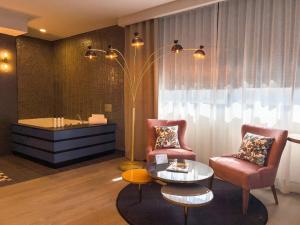 a living room with two chairs and a table at Hotel Indigo Madrid - Gran Vía by IHG in Madrid