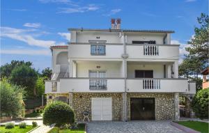 a large white building with two balconies at Nice Apartment In Silo With Wifi in Šilo +21 photos