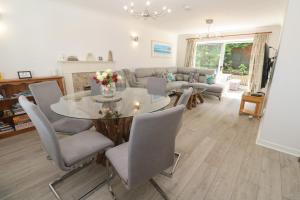 a living room with a table and chairs and a couch at Jaluna in St Ives