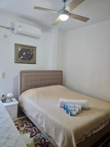 a bedroom with a bed with a ceiling fan at Sofia's Seaview Villa Near Airport And Beach in Artemida