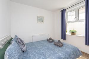 a bedroom with a bed with two teddy bears on it at Glenmore Lodge in Belfast
