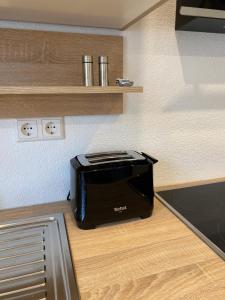 a black toaster sitting on top of a kitchen counter at Casa Tandri am Rebenweg in Bermatingen +12 photos