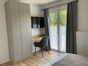 Telewizja i/lub zestaw kina domowego w obiekcie Seaways Apartments