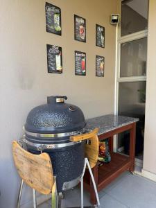 a grill sitting on top of a table with chairs at Stylish Ballito Home - Zimbali Wedge in Ballito