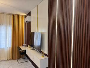 哈科特港Spacious Studio Apartment in Portharcourt的酒店的客房配有电视、书桌和